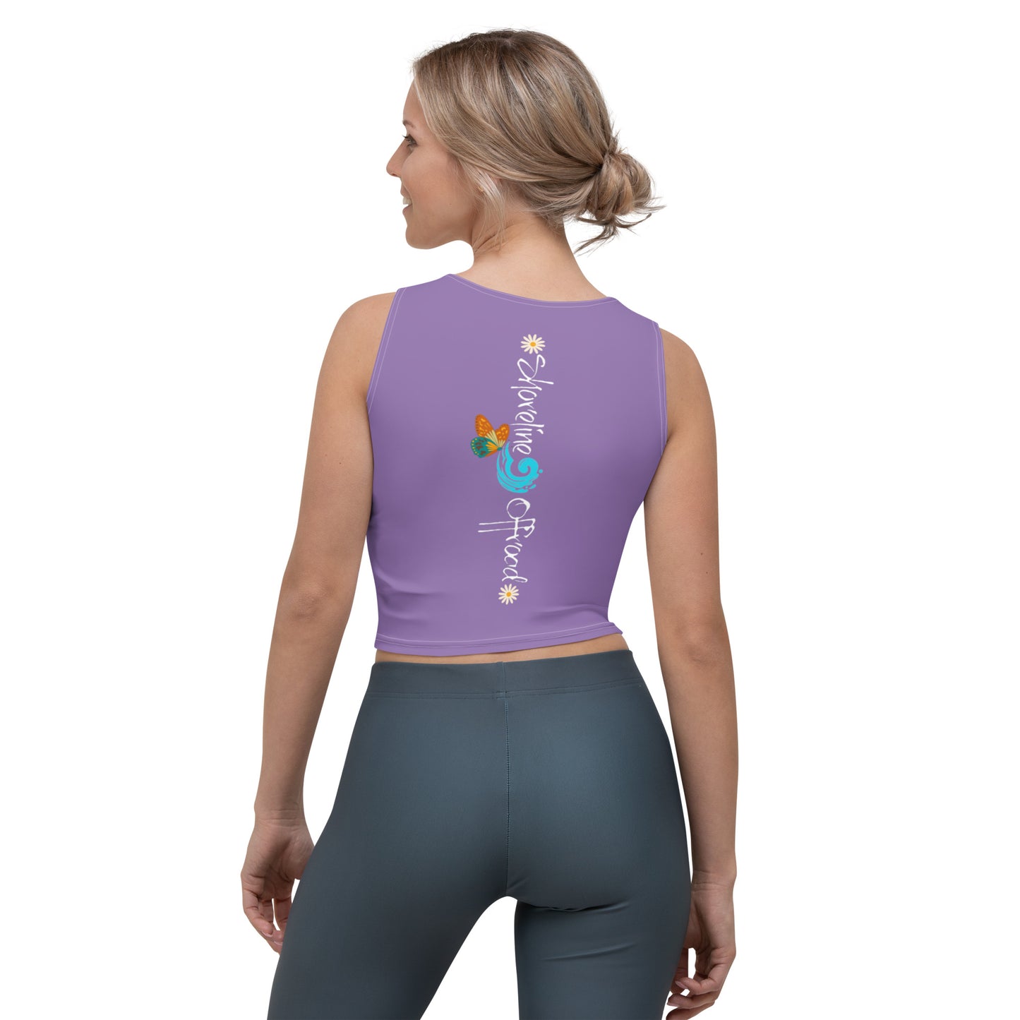 a woman wearing a purple crop top with a flower design