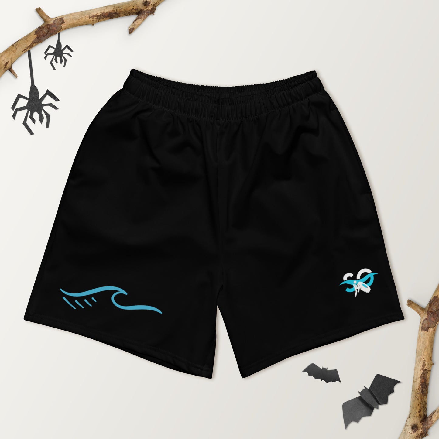 a pair of black shorts with a bat on it