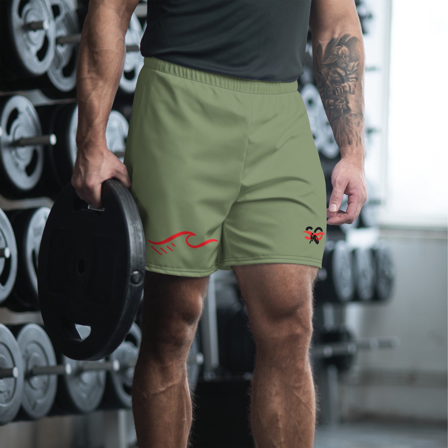 a man holding a weight plate in a gym