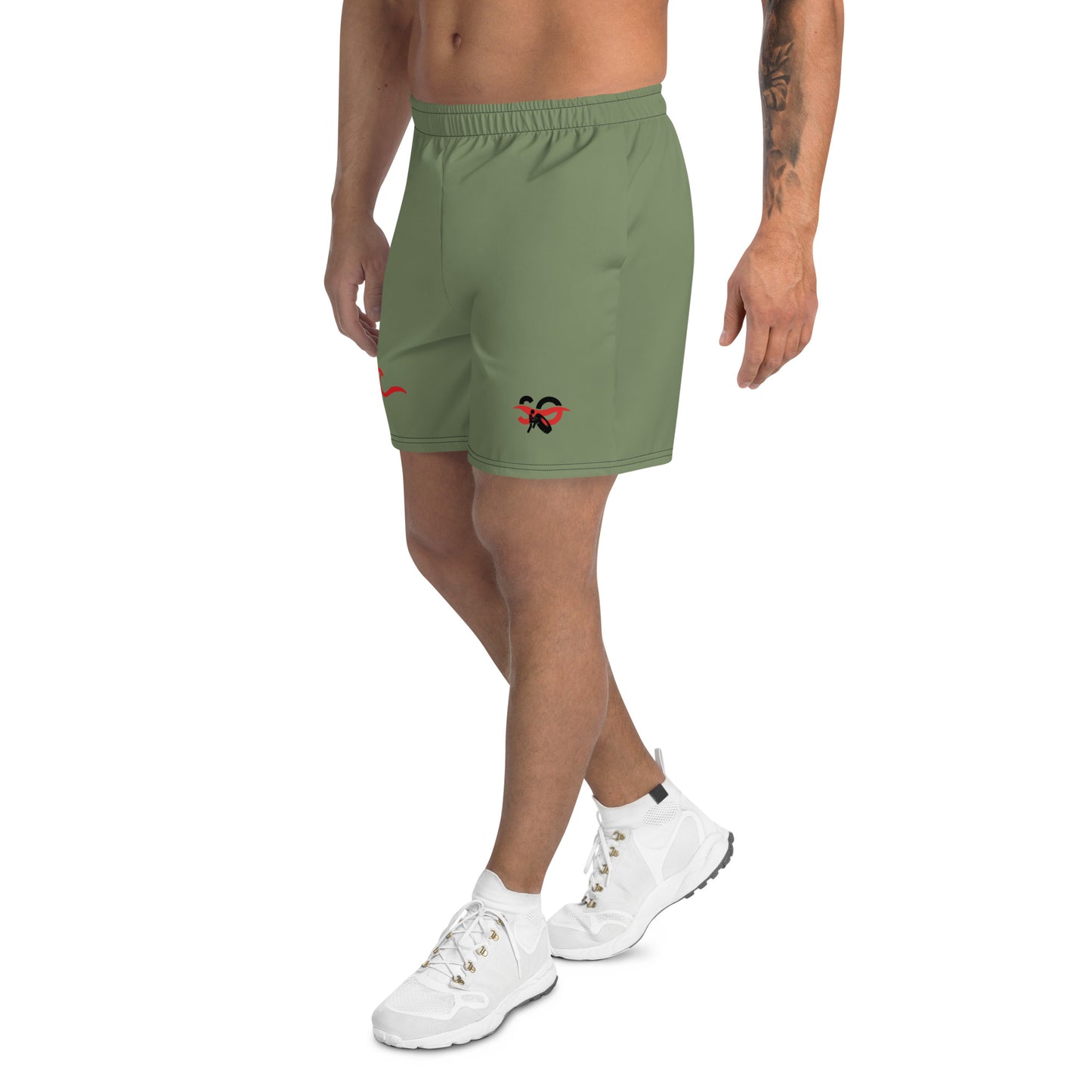 a man wearing a green shorts with a red butterfly on it