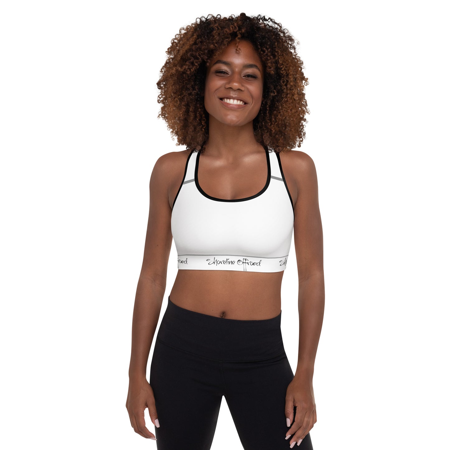 a woman wearing a white sports bra top and black leggings