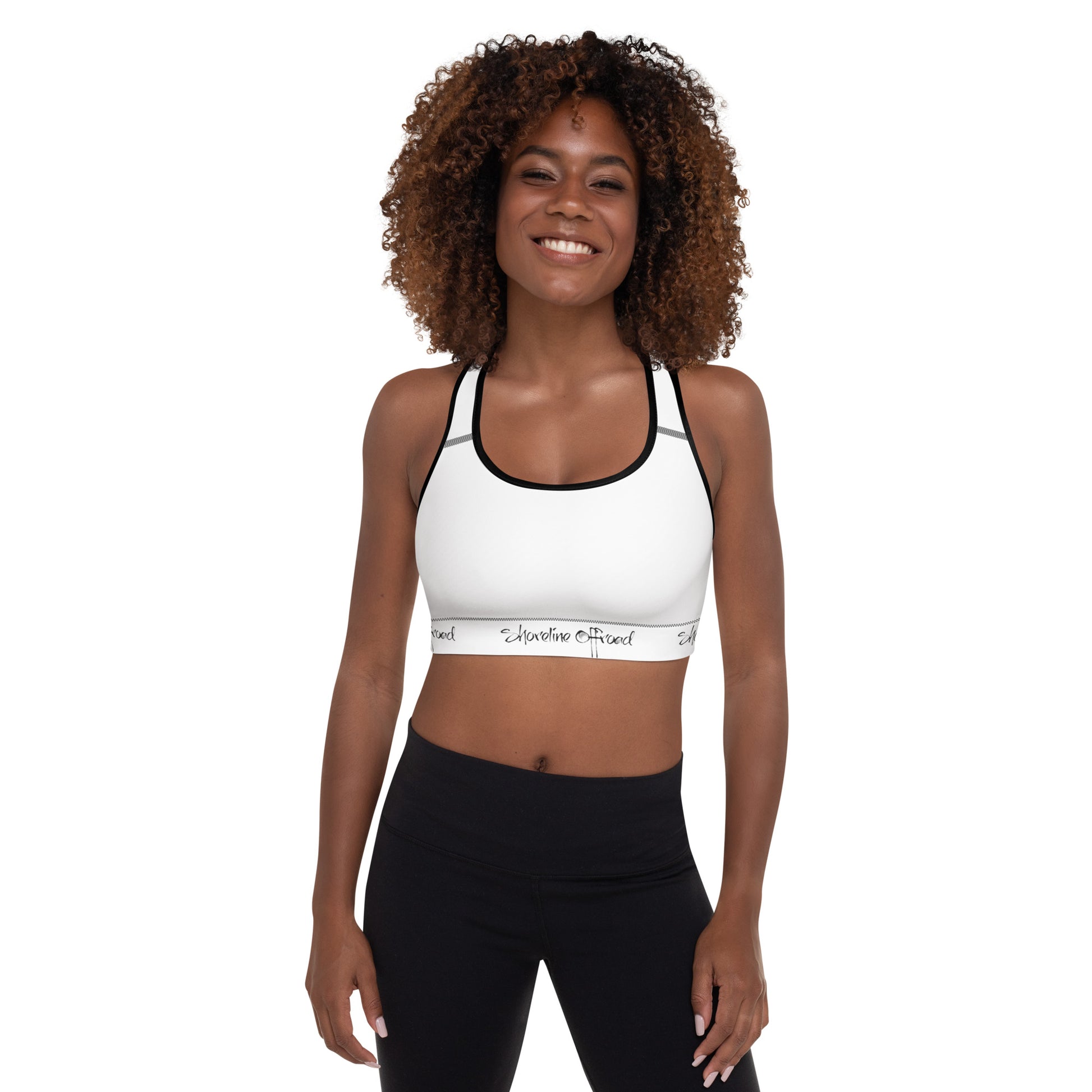 a woman wearing a white sports bra top and black leggings