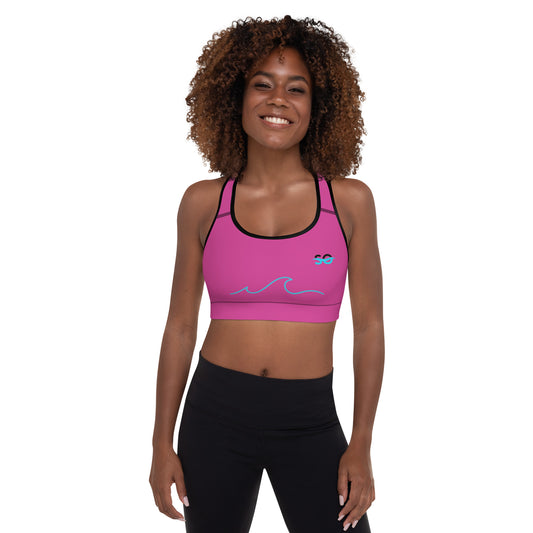 a woman wearing a pink sports bra top and black leggings