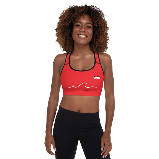 a woman wearing a red sports bra top and black leggings