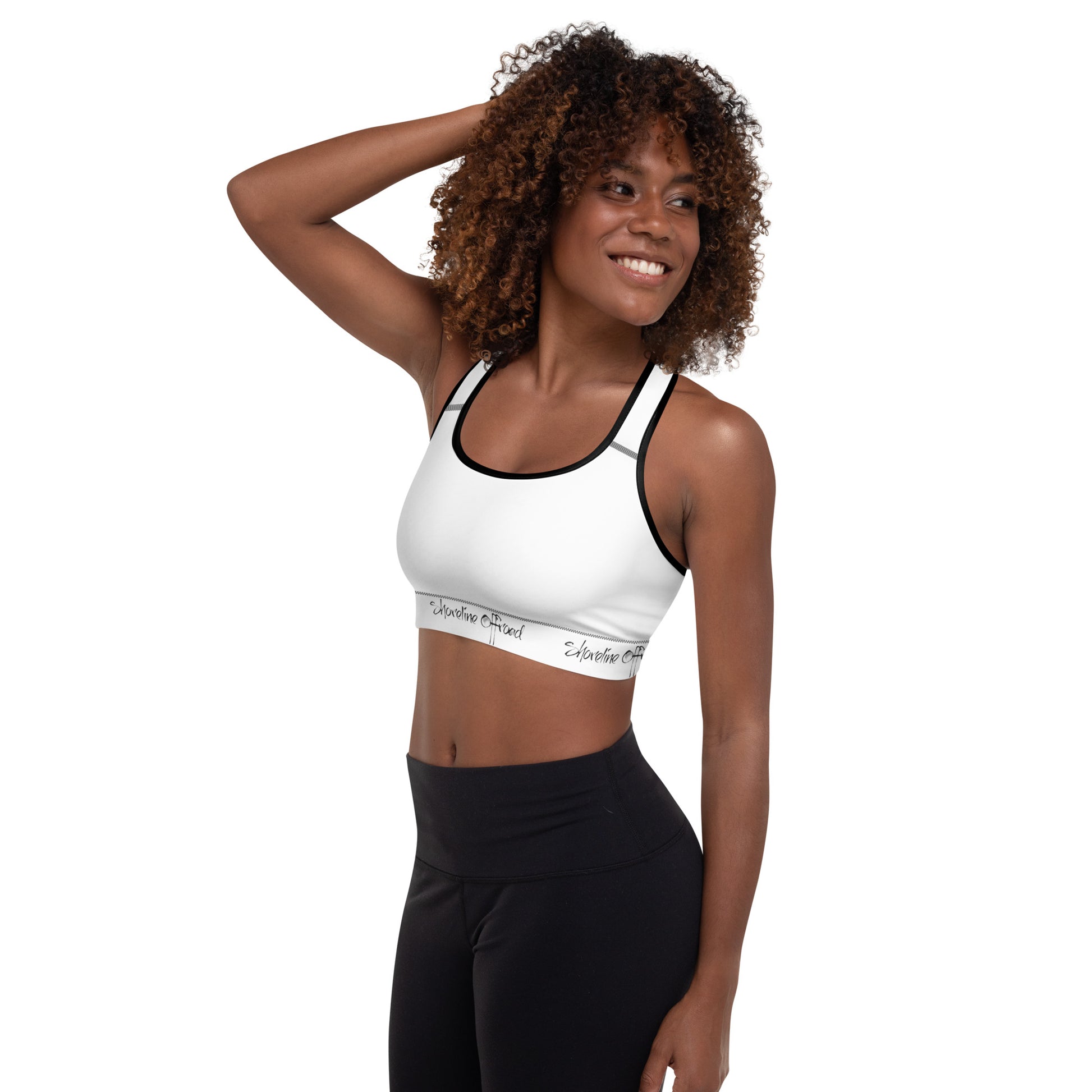 a woman wearing a white sports bra top and black leggings