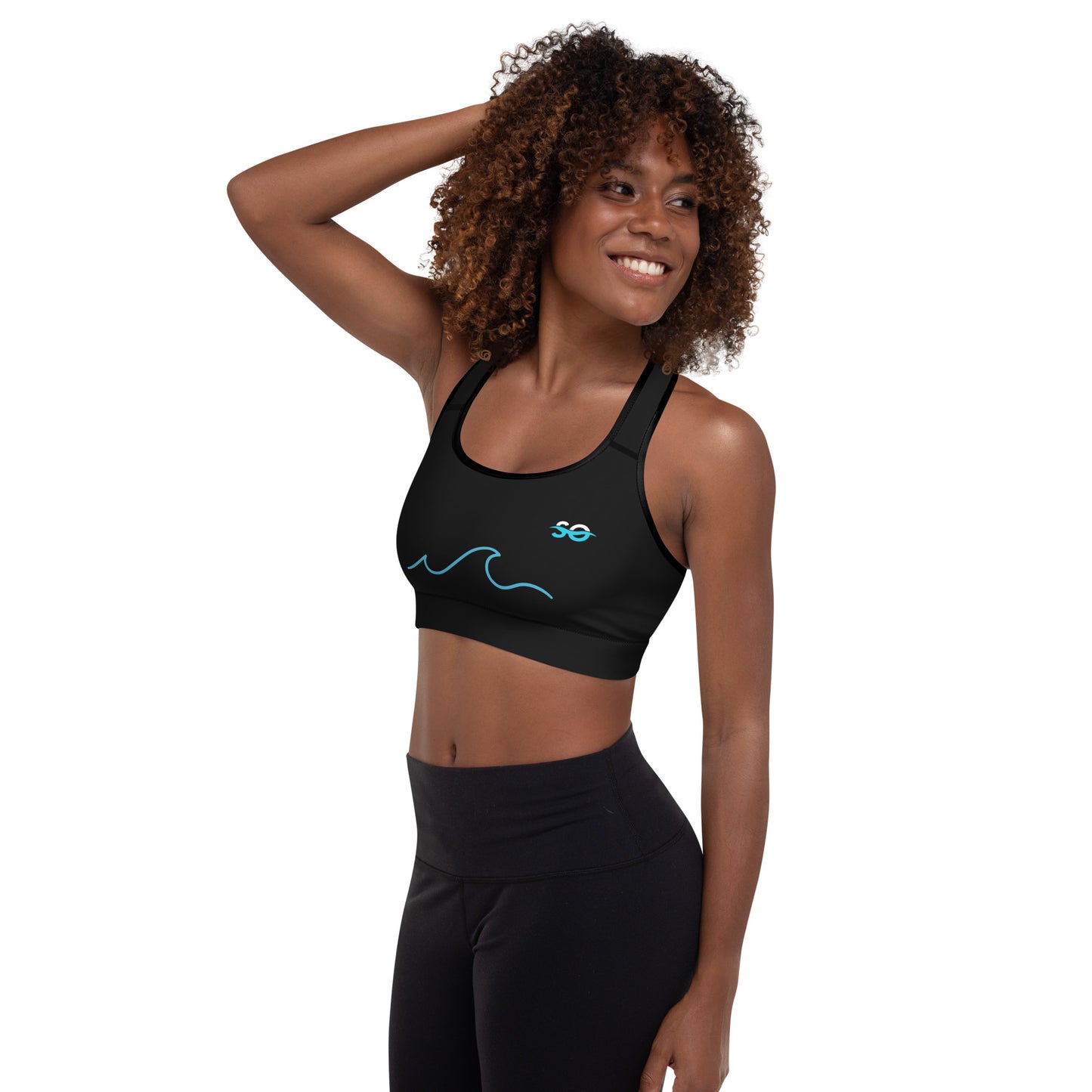 a woman wearing a black sports bra with a blue wave on it