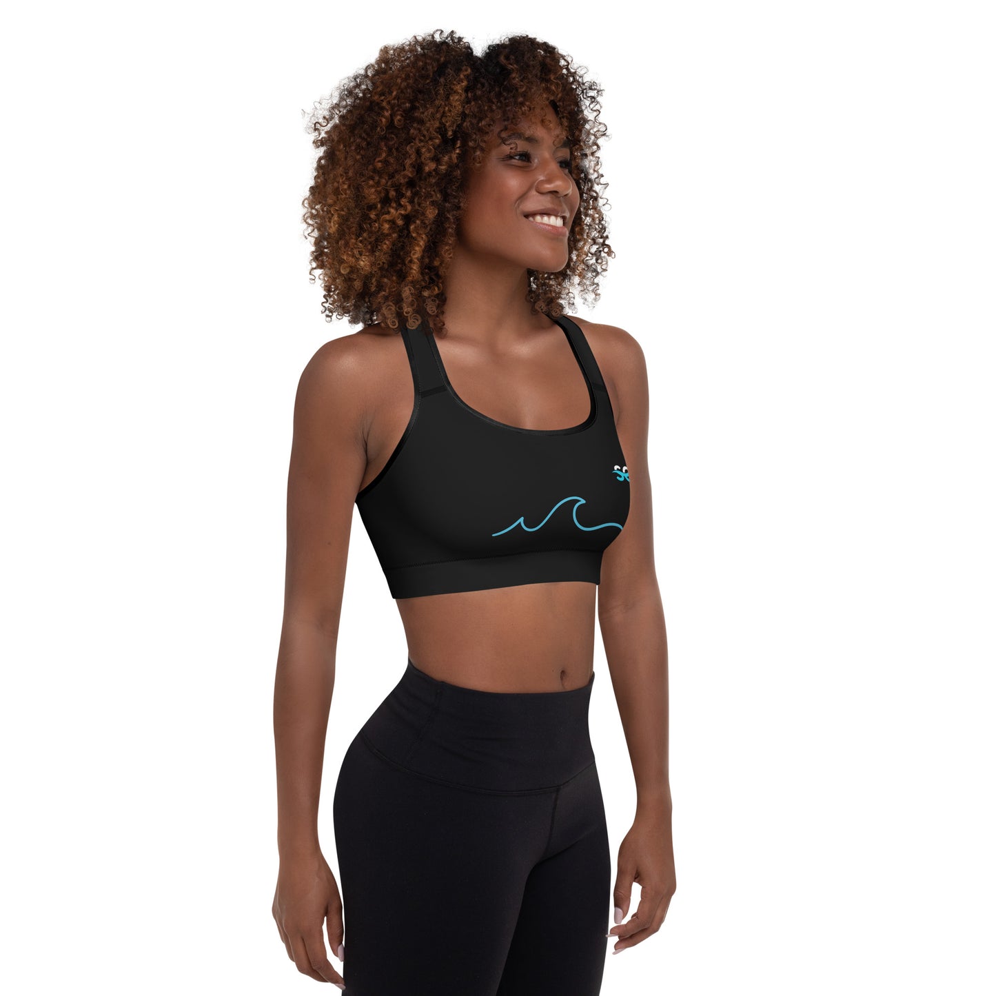 a woman wearing a black sports bra with a blue wave on it