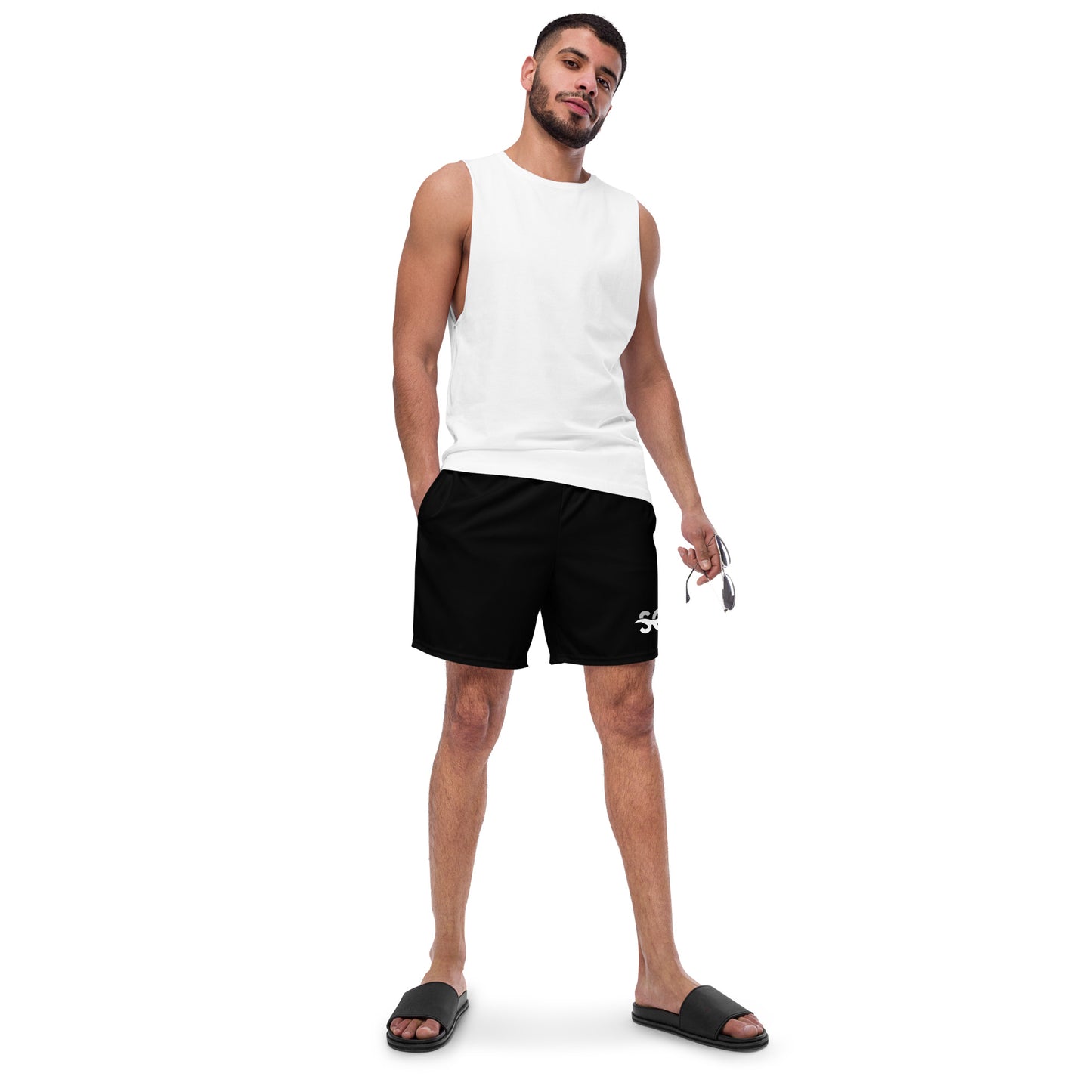 a man in a white tank top and black shorts