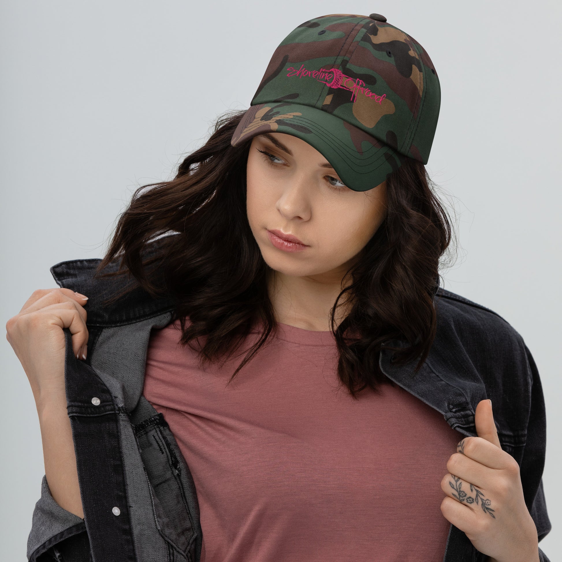 a woman wearing a camo hat and jacket