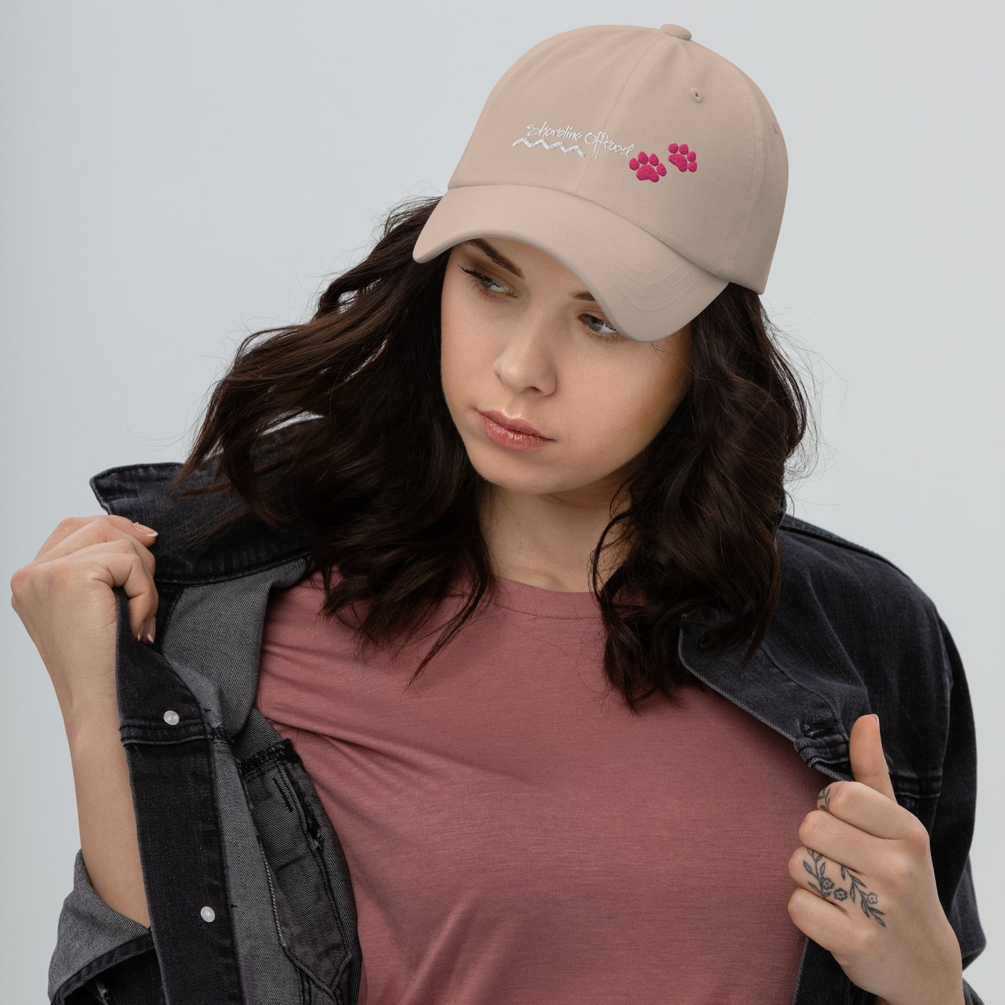 a woman wearing a pink shirt and a hat