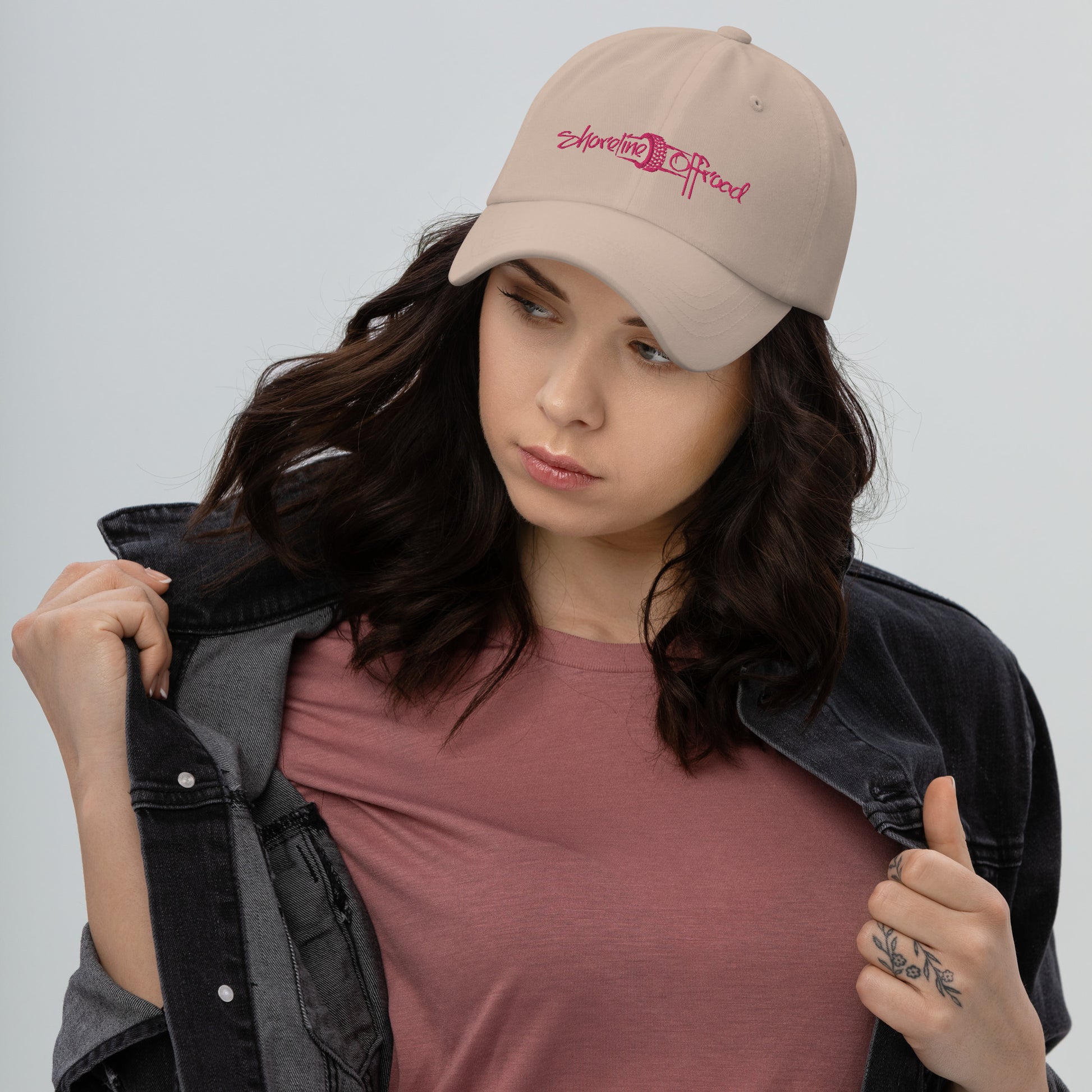 a woman wearing a pink shirt and a hat