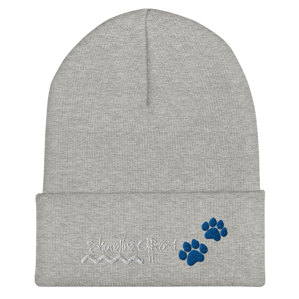 a grey beanie with blue paw prints on it