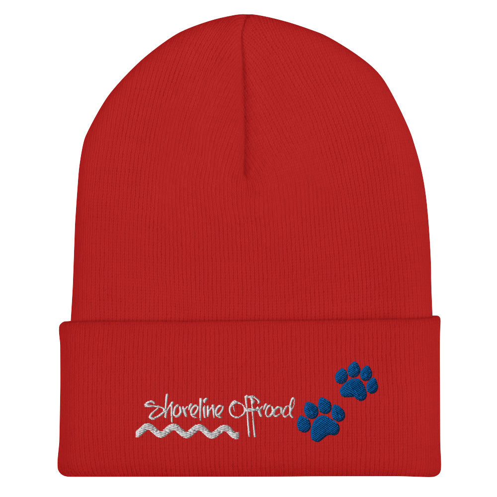 a red beanie with a blue paw on it