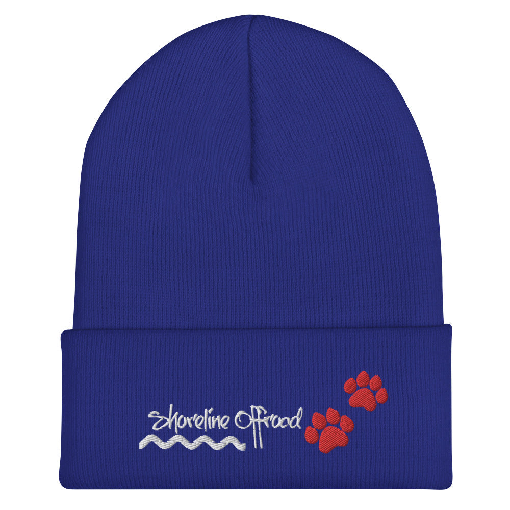 a blue beanie with a red paw on it