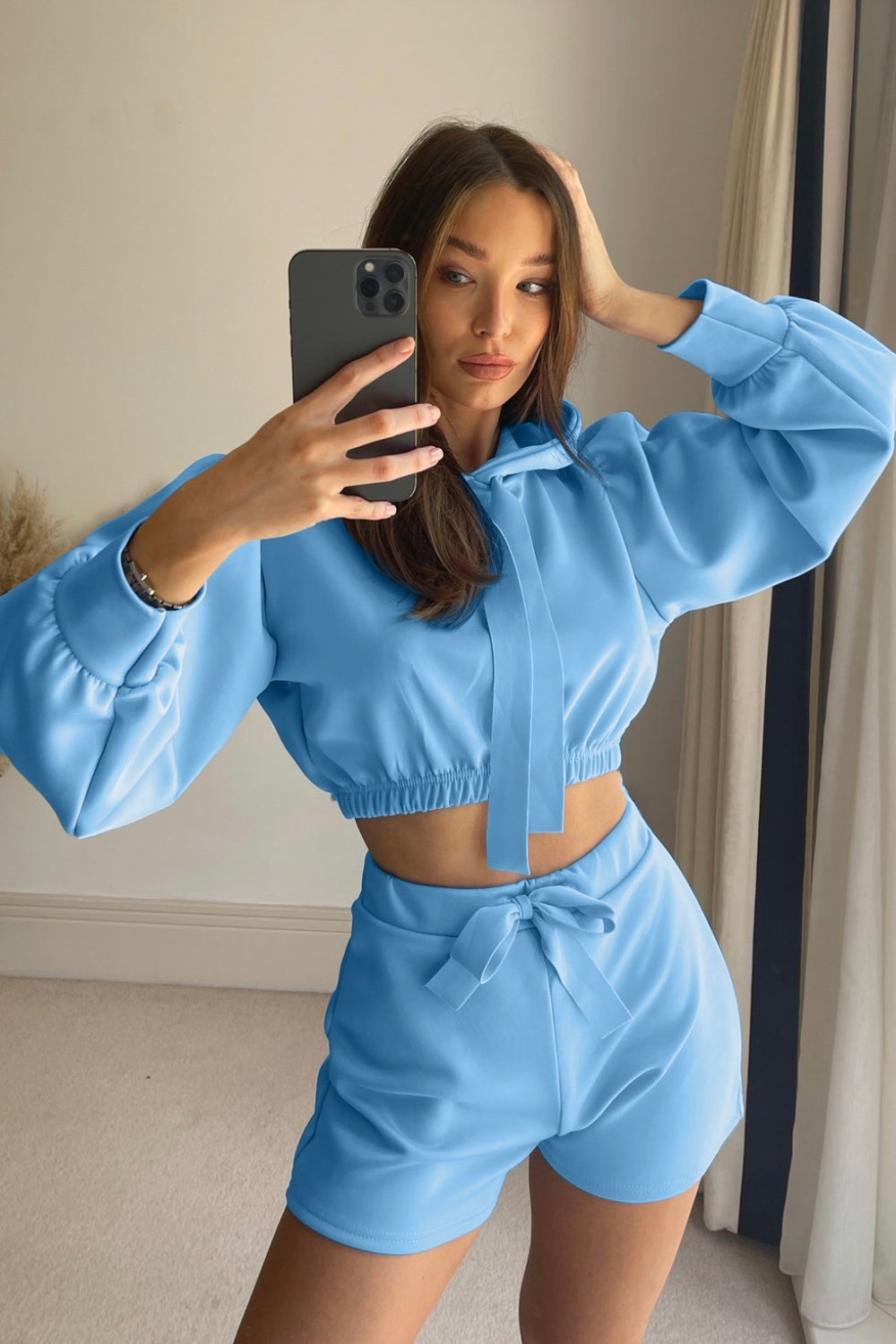 a woman taking a selfie in a blue outfit