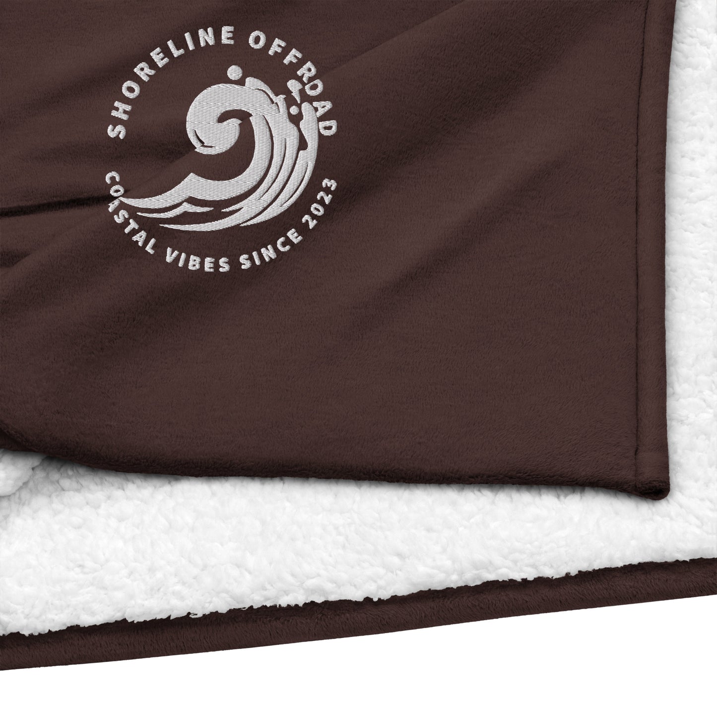 a towel with a brown and white logo on it