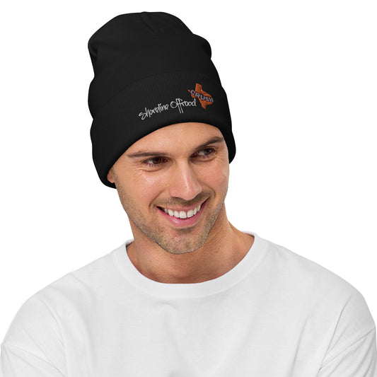 a man wearing a black beanie with a butterfly on it