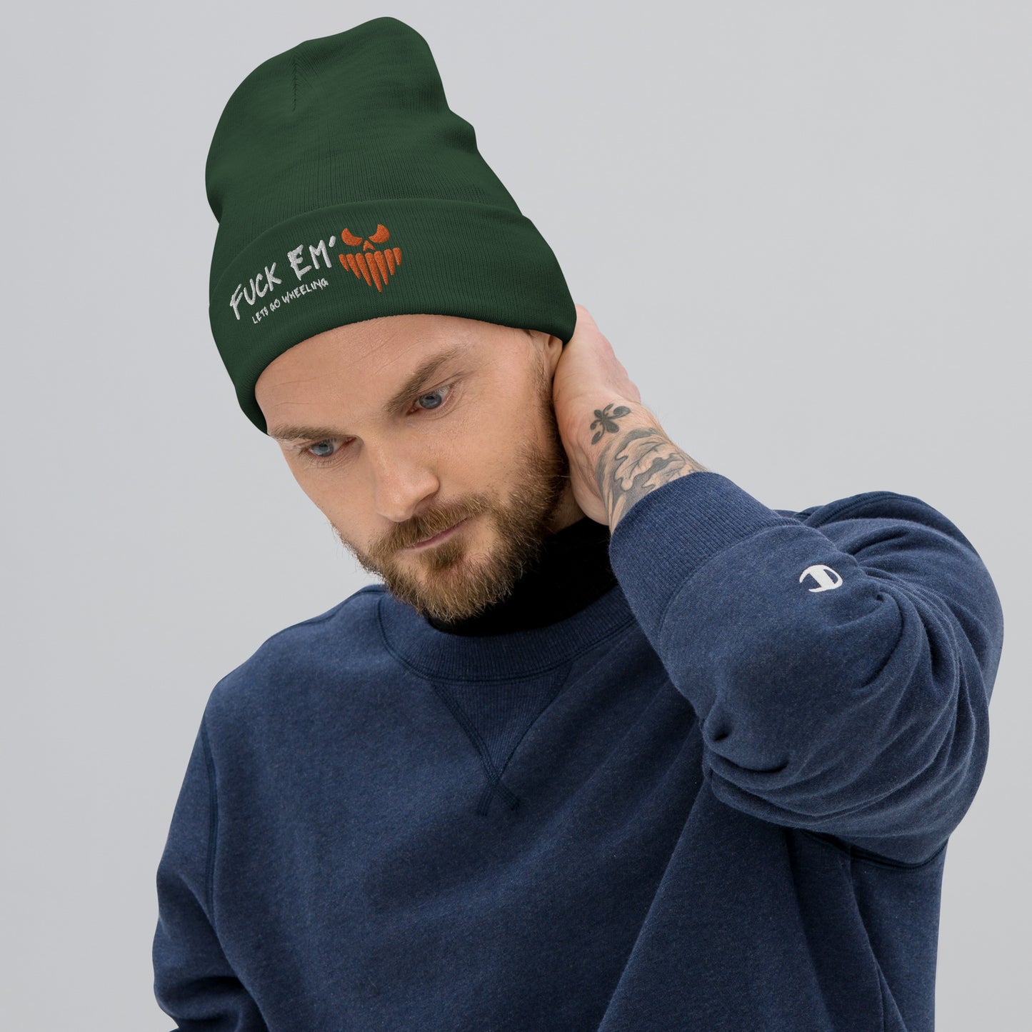 a man with a beard wearing a green beanie