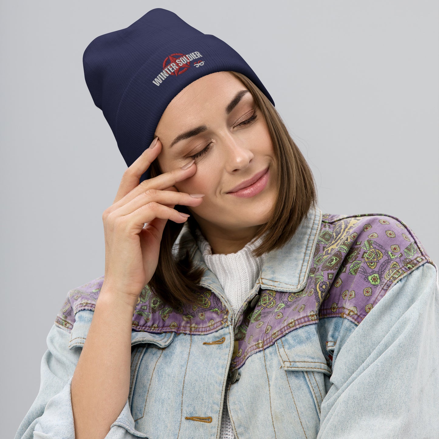 a woman in a denim jacket is talking on a cell phone
