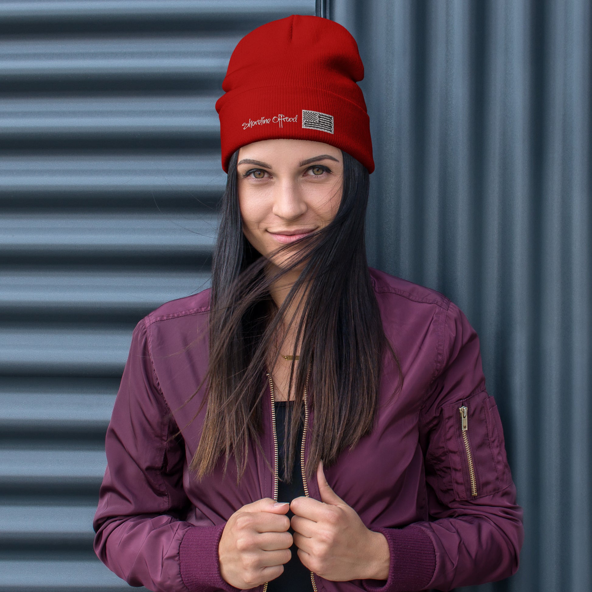 a woman wearing a red hat and a purple jacket