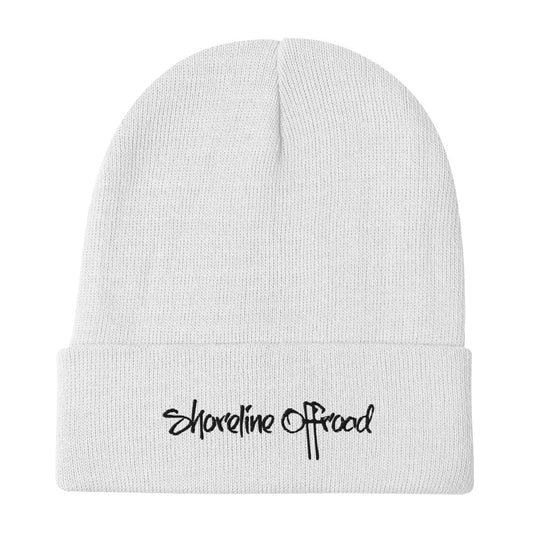 a white beanie with the word shoreline on it