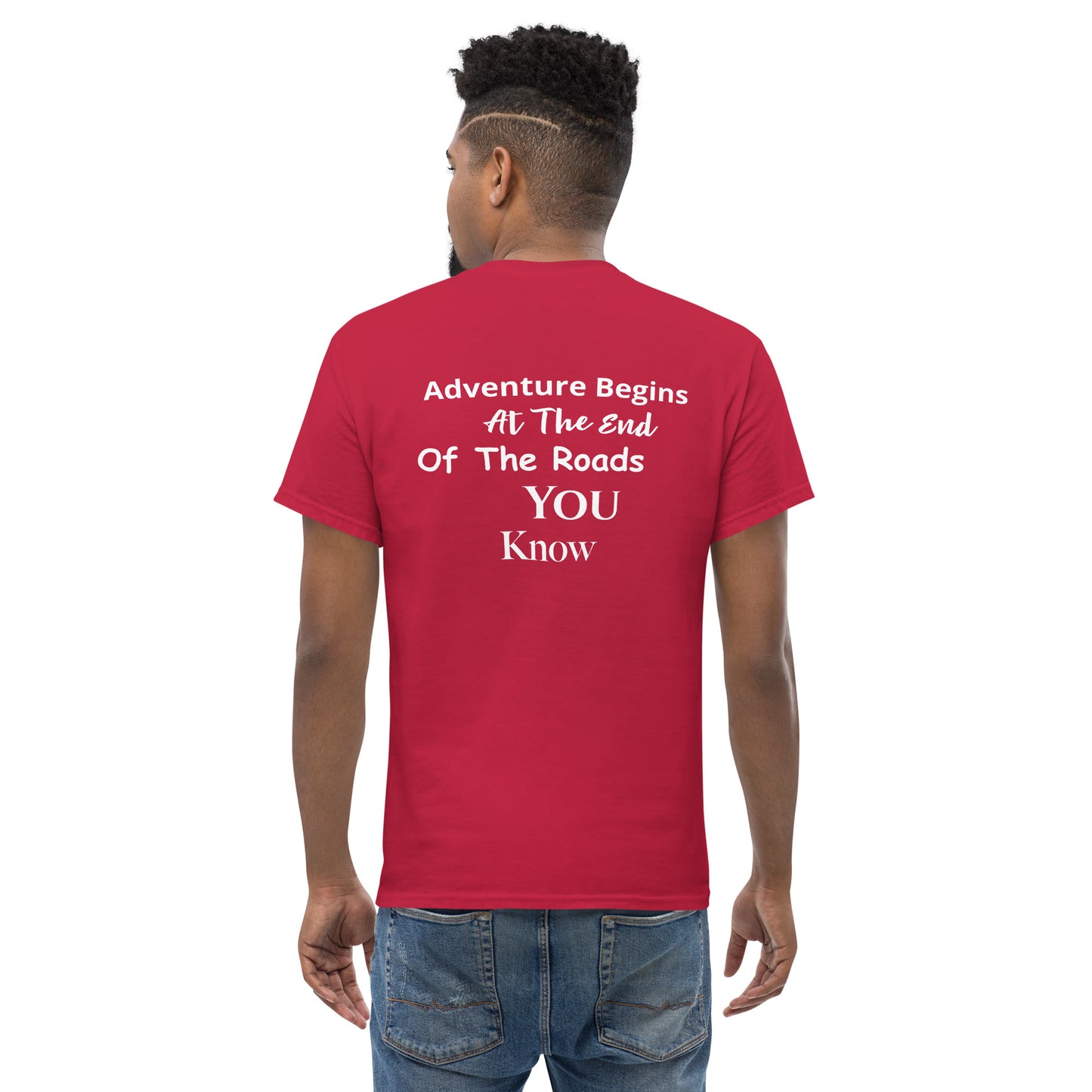 a man wearing a red t - shirt that says adventure begins at the end of