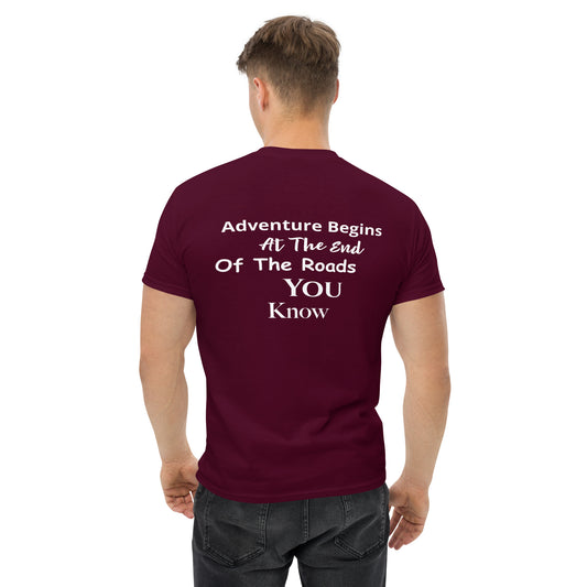 a man wearing a maroon t - shirt that says adventure begins at the end of