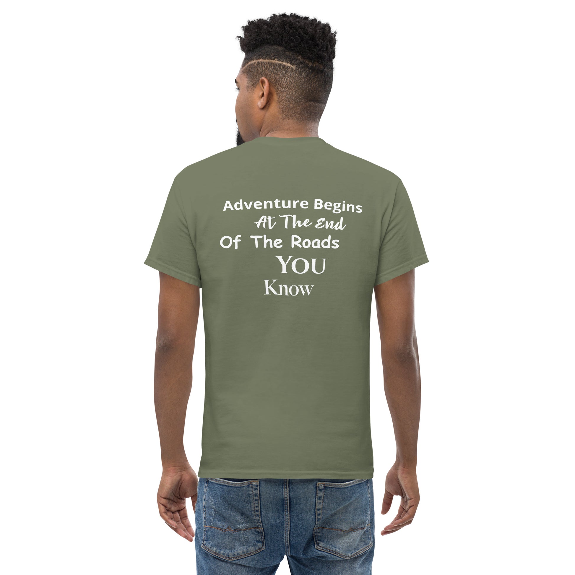 a man wearing a green t - shirt that says adventure begins at the end of