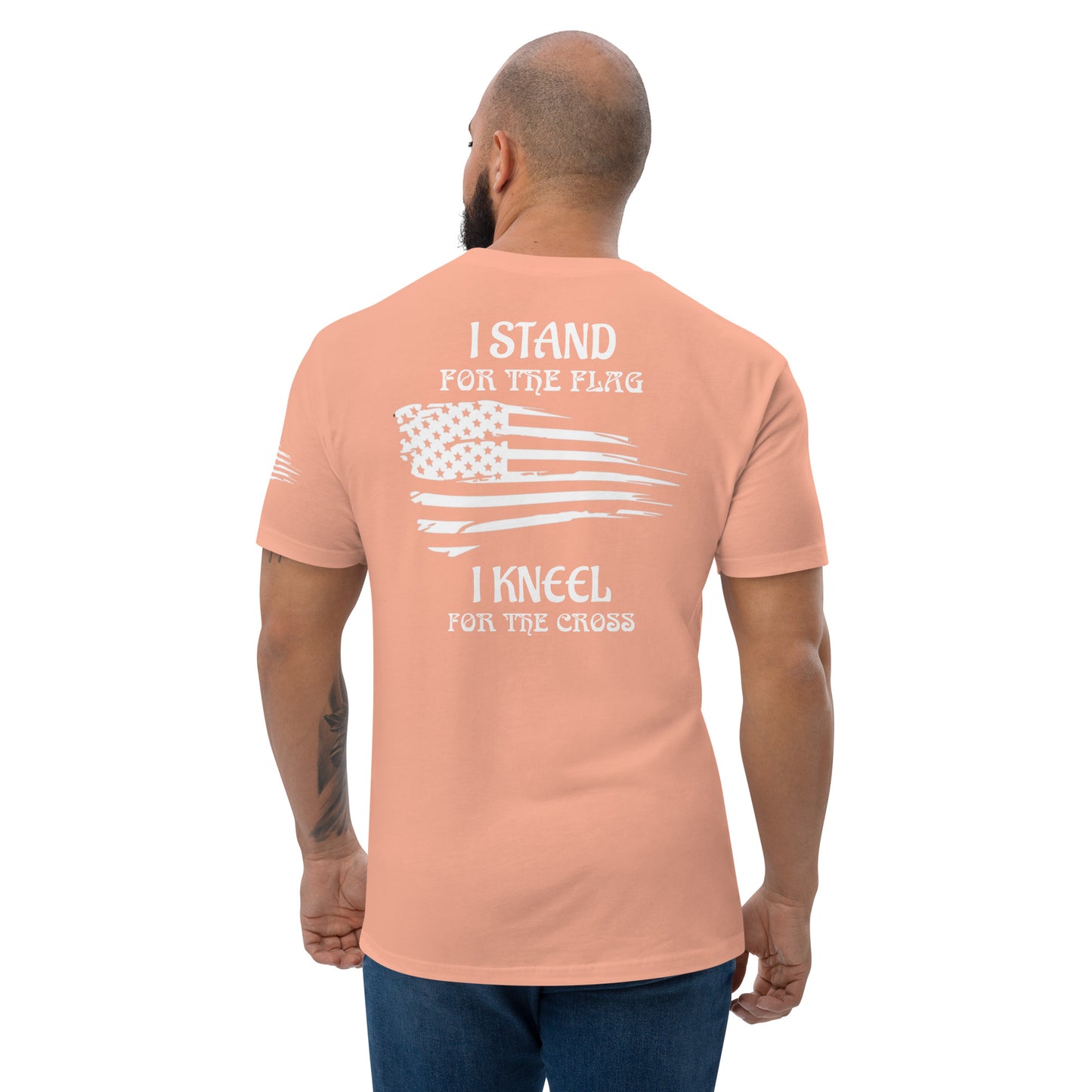 a man wearing a pink t - shirt that says i stand for the flag