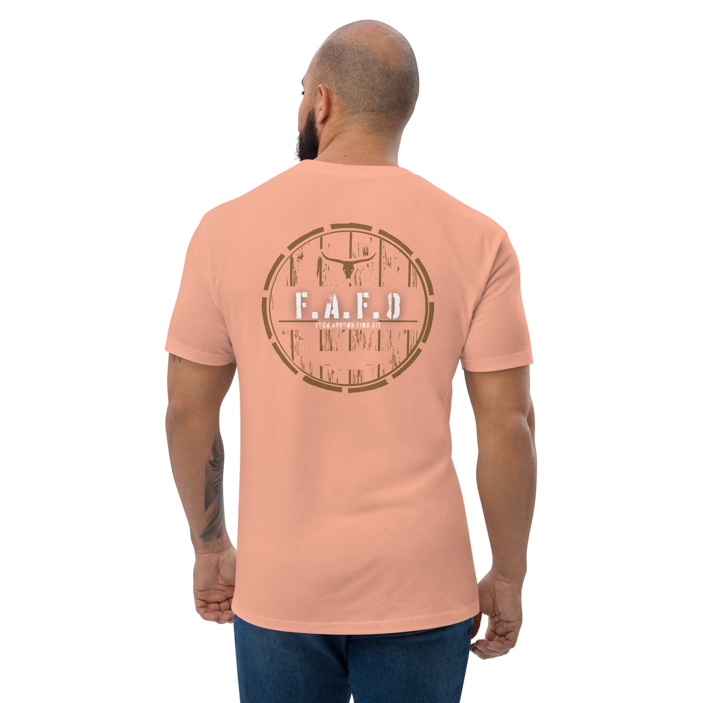 a man wearing a peach colored t - shirt with the word faafd printed