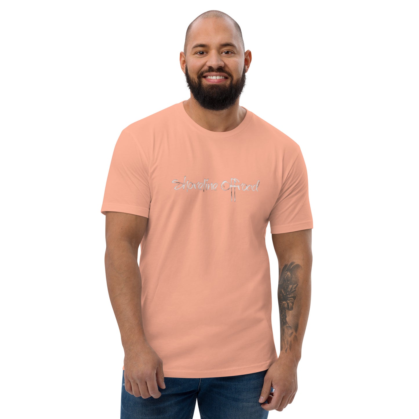 a man with a beard wearing a pink shirt