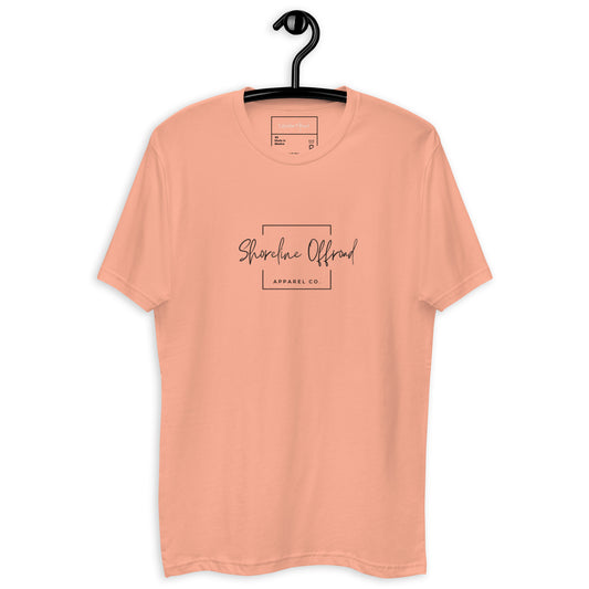 a peach colored t - shirt with a black hanger