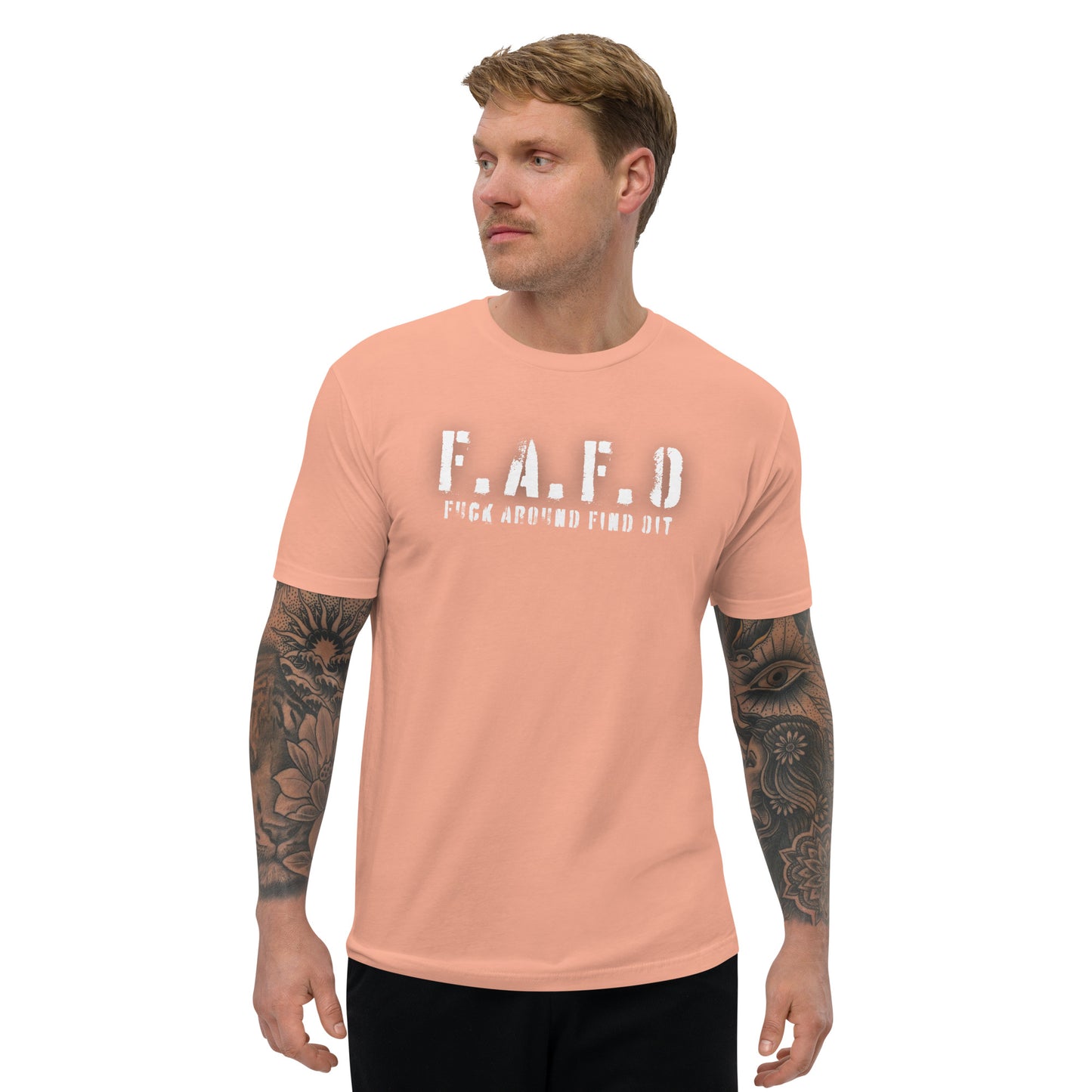 a man with a tattooed arm wearing a peach t - shirt