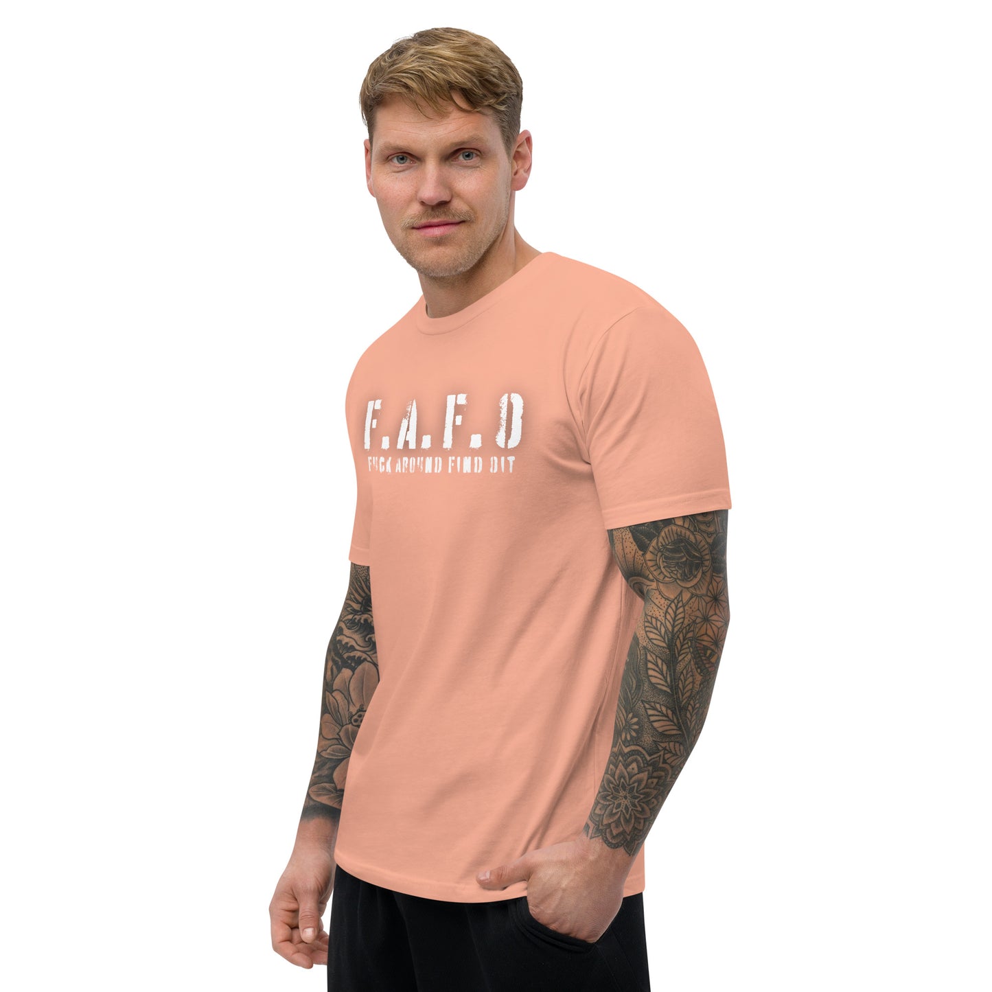 a man with a tattooed arm wearing a pink t - shirt