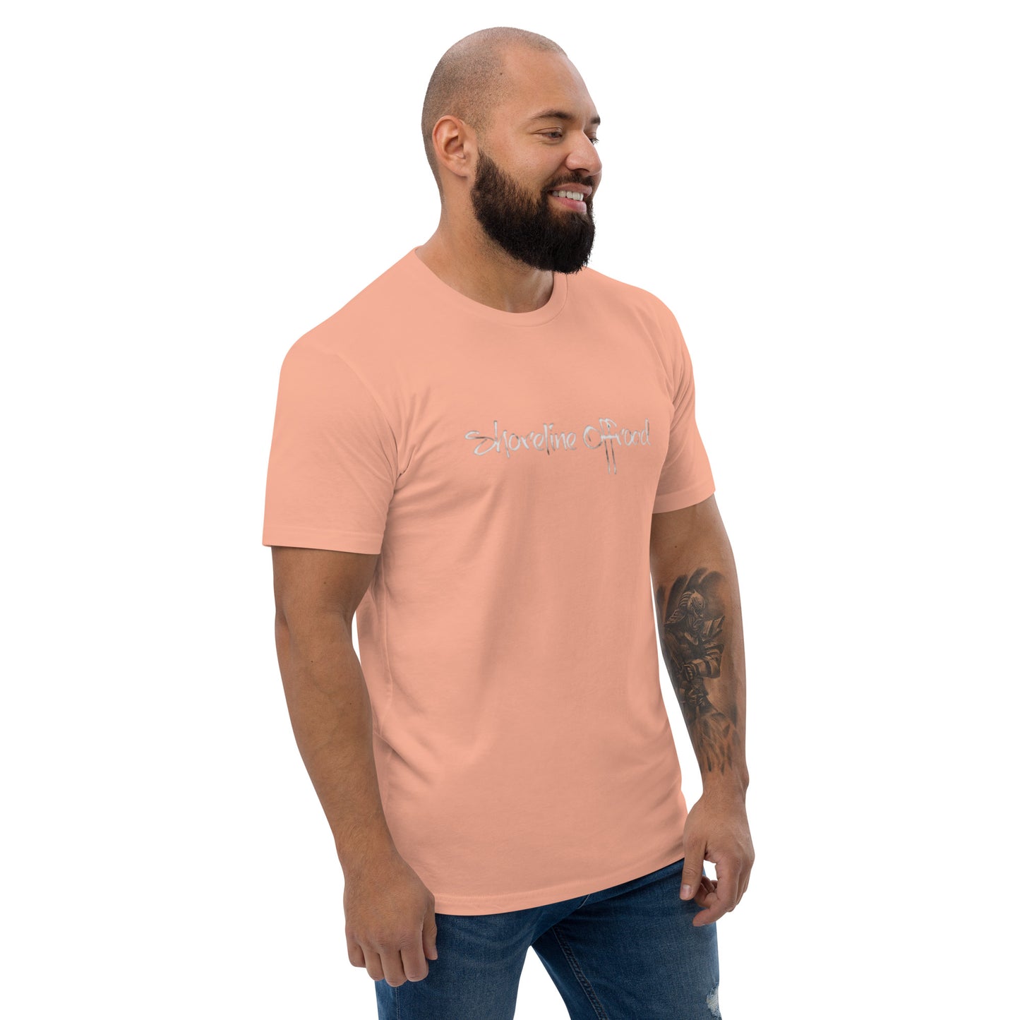 a man with a beard wearing a pink shirt