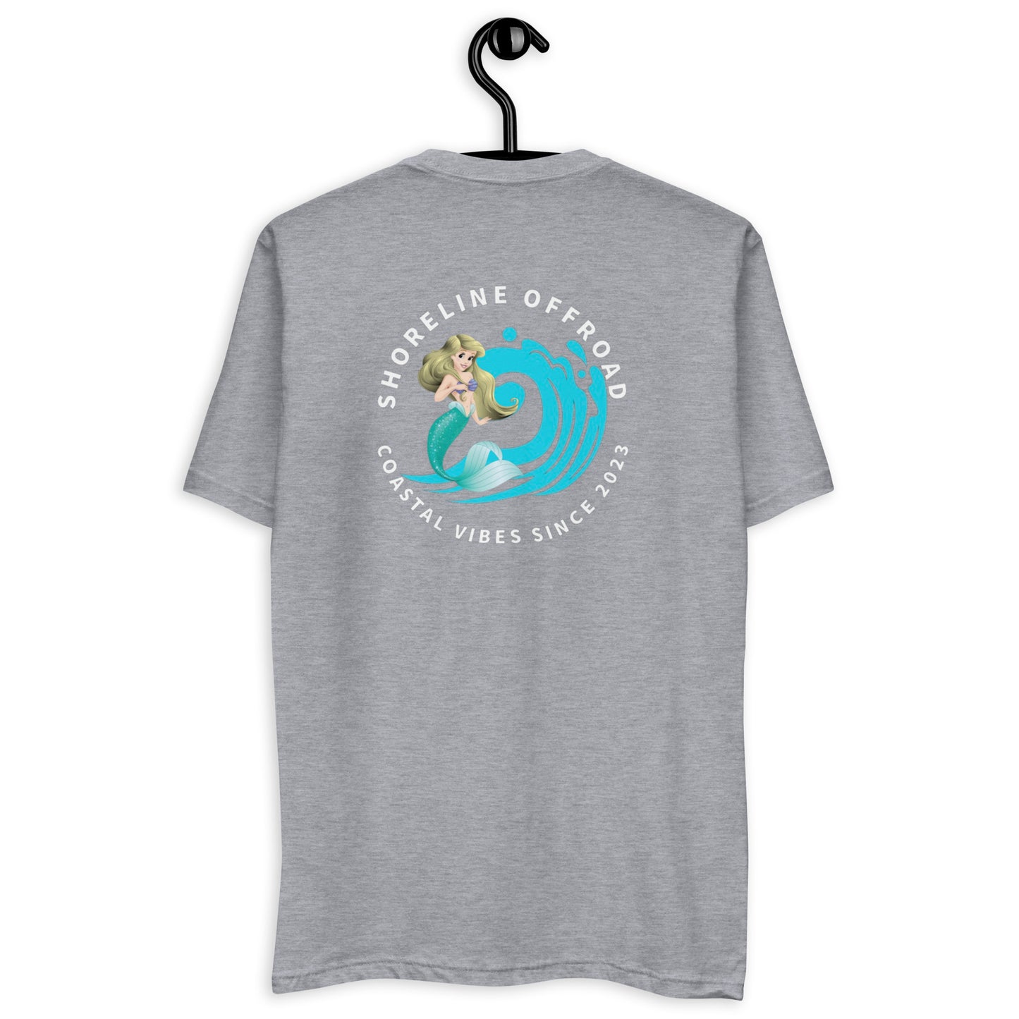 a grey t - shirt with a woman surfing on it