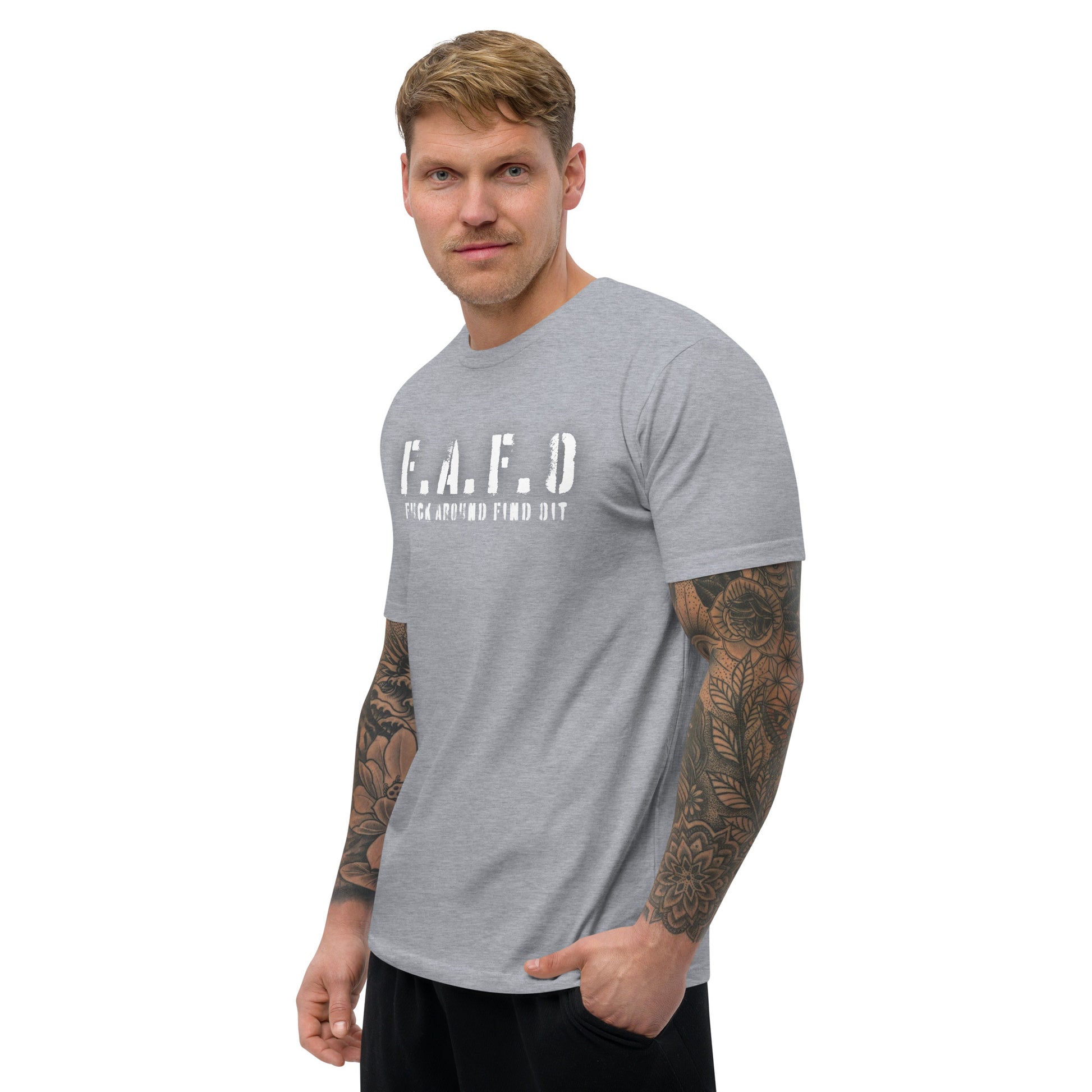 a man with a tattooed arm wearing a grey t - shirt