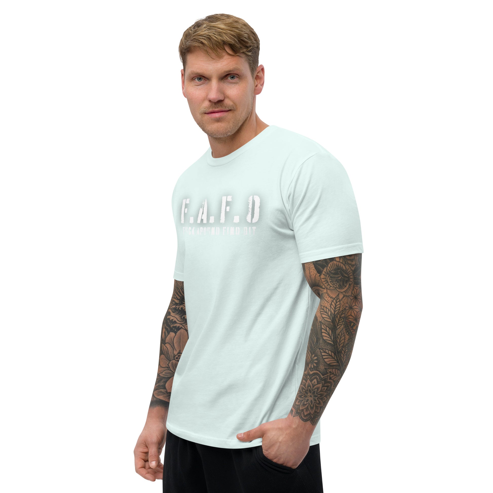 a man with a tattooed arm wearing a white t - shirt