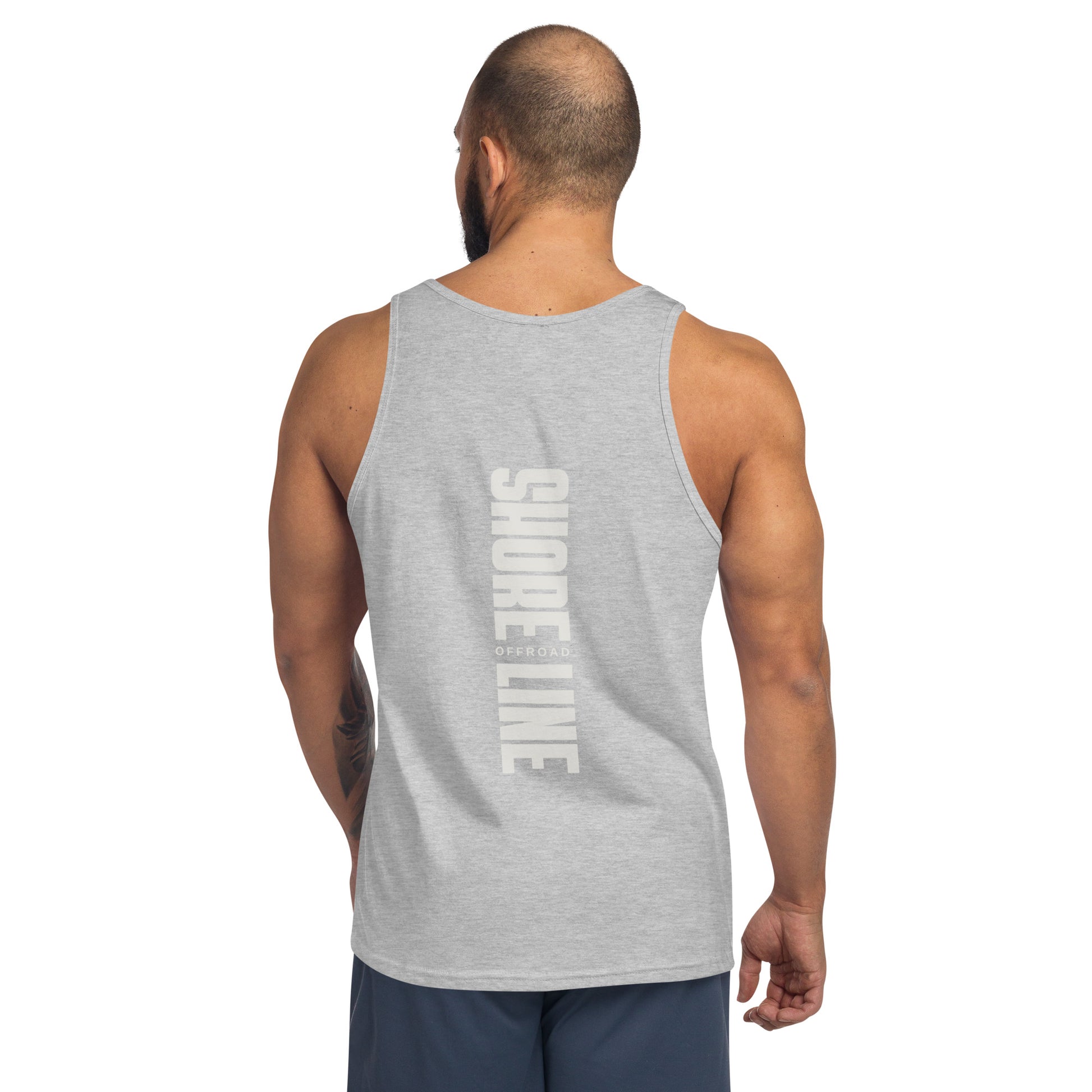 a man wearing a grey tank top with the words show me on it