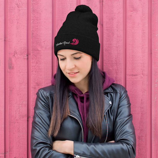 a woman wearing a black beanie and a leather jacket