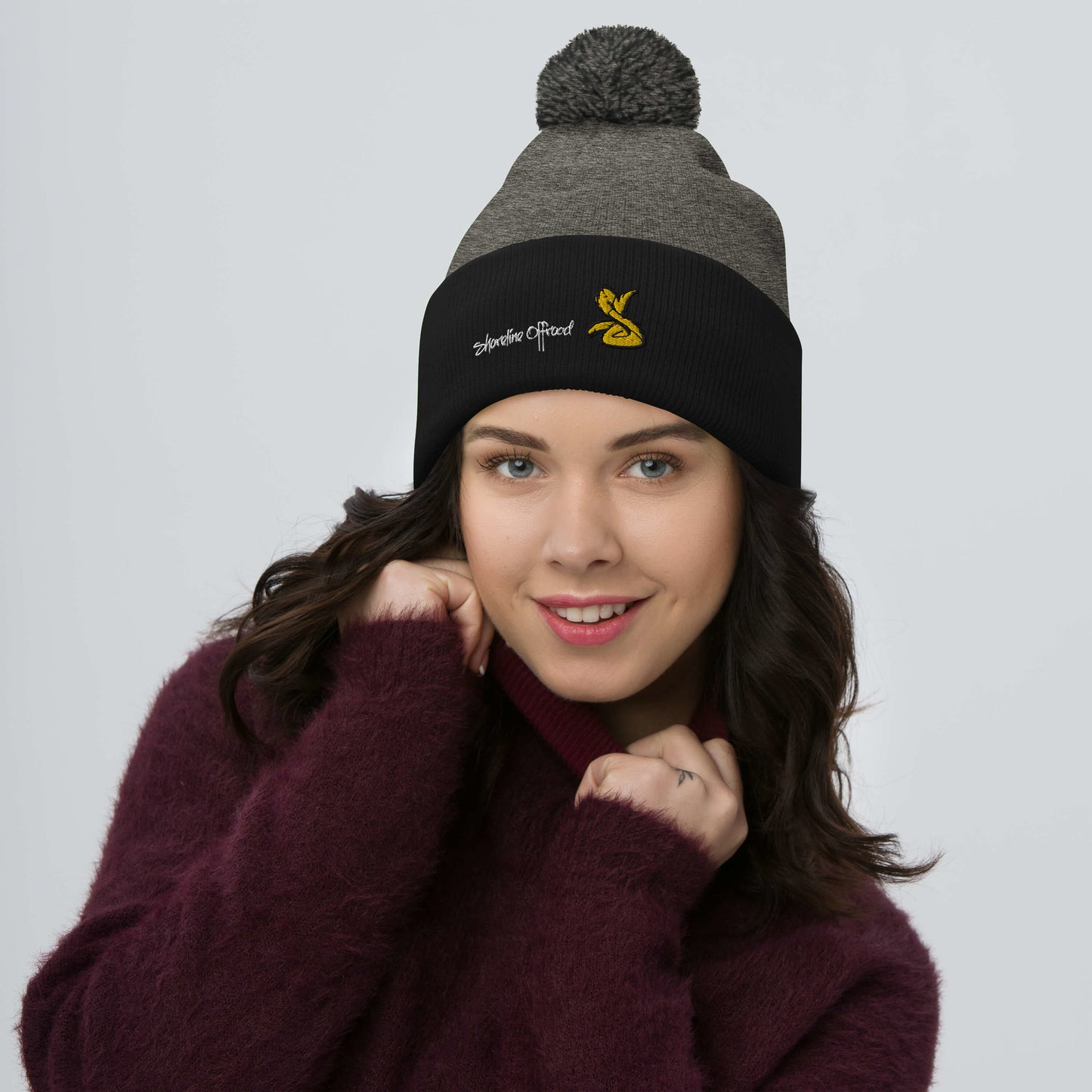 a woman wearing a beanie and a sweater