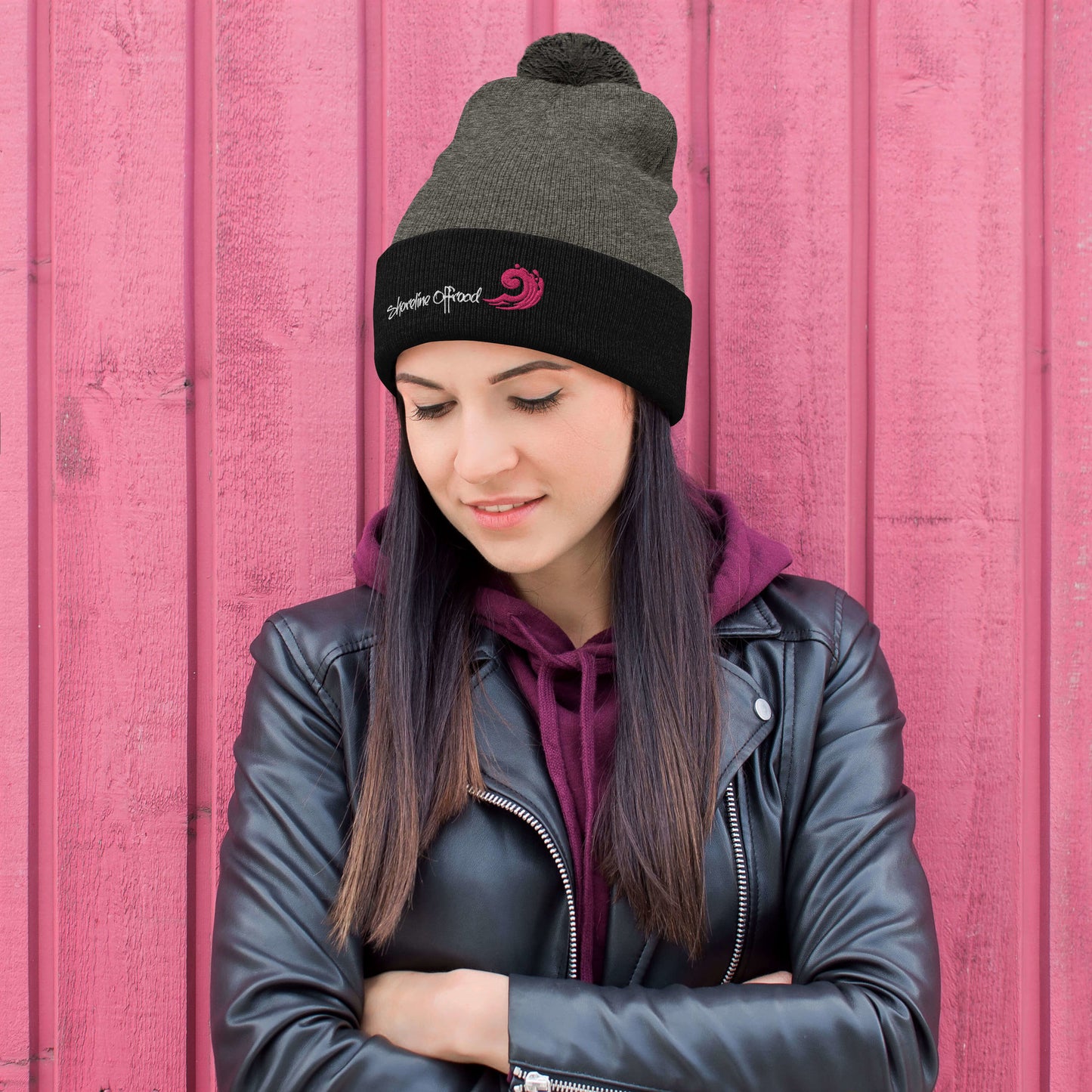 a woman wearing a black jacket and a black beanie