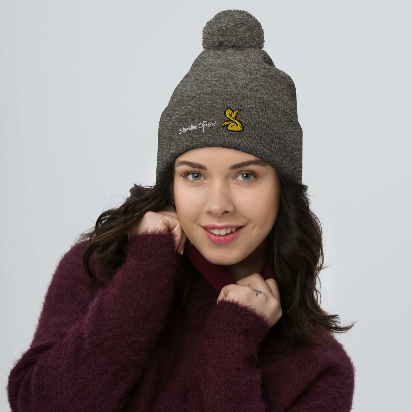 a woman wearing a beanie and a sweater