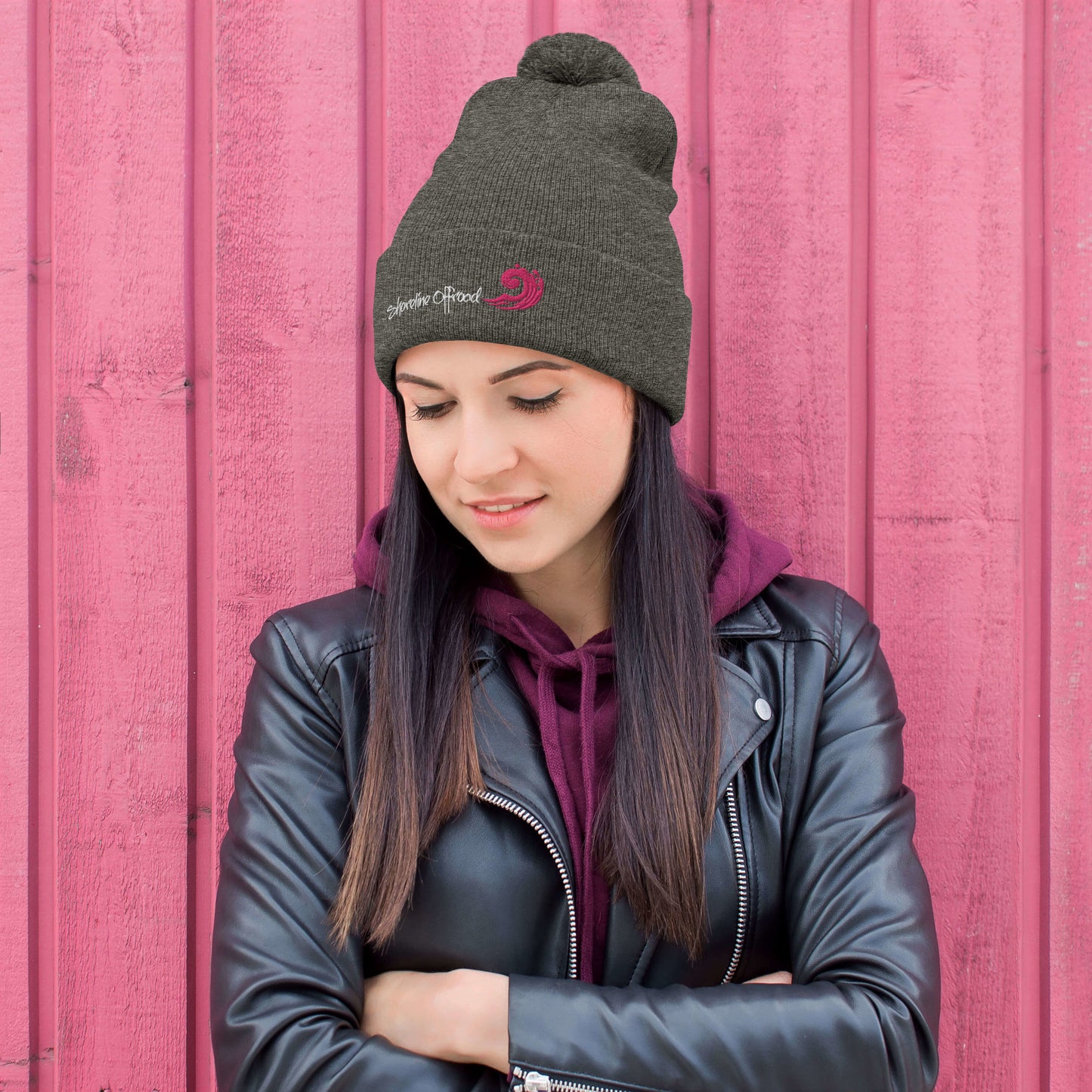 a woman wearing a black leather jacket and a beanie