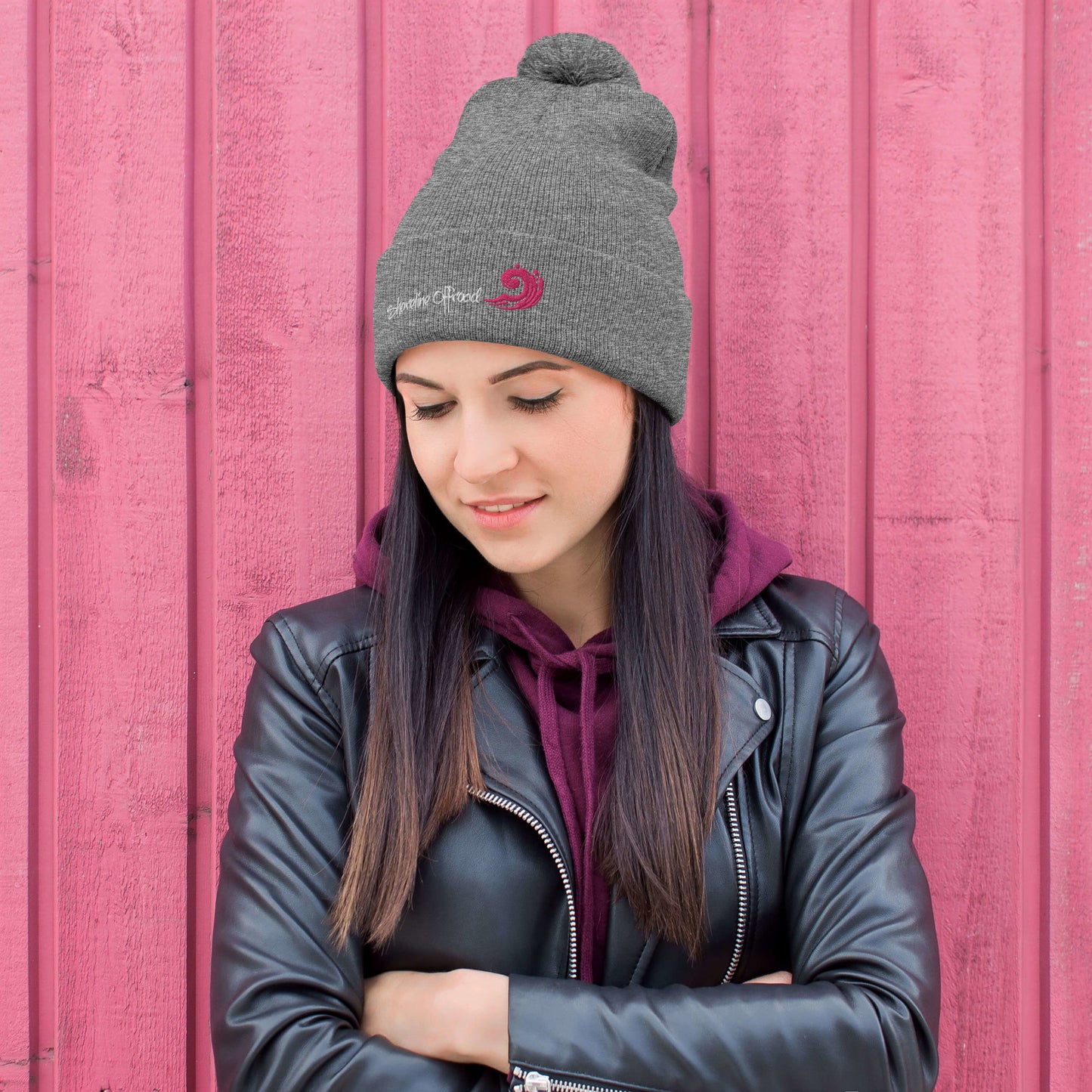 a woman wearing a black jacket and a gray hat