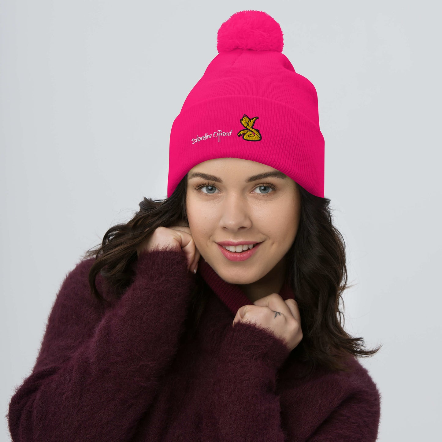 a woman wearing a pink hat and a purple sweater