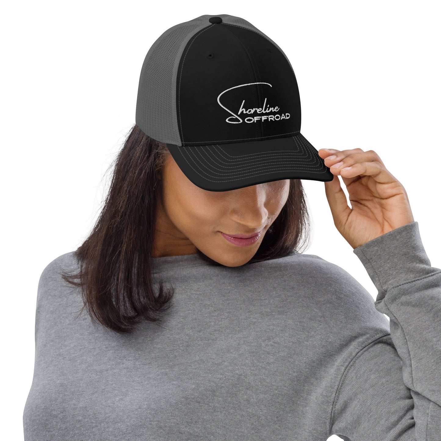 a woman wearing a black hat with a white logo