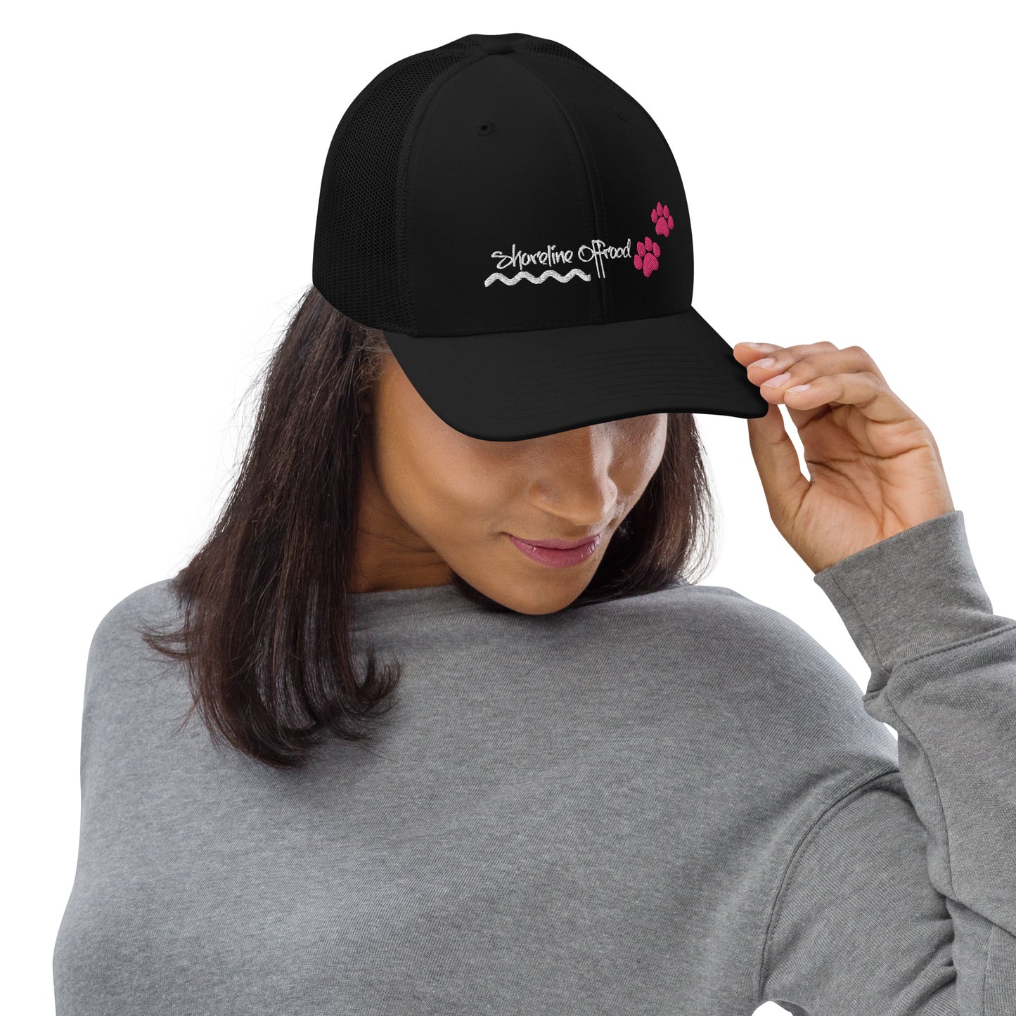 a woman wearing a black hat with pink flowers on it