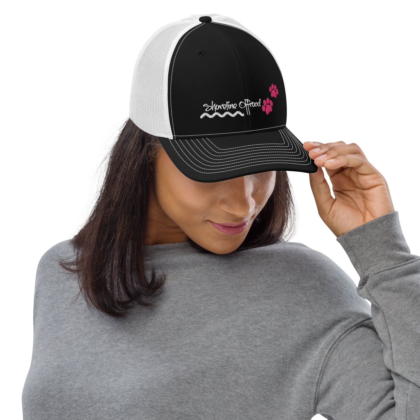 a woman wearing a black and white trucker hat