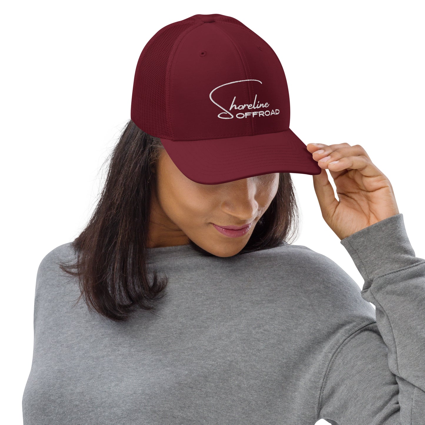 a woman wearing a red hat with the name of a company on it